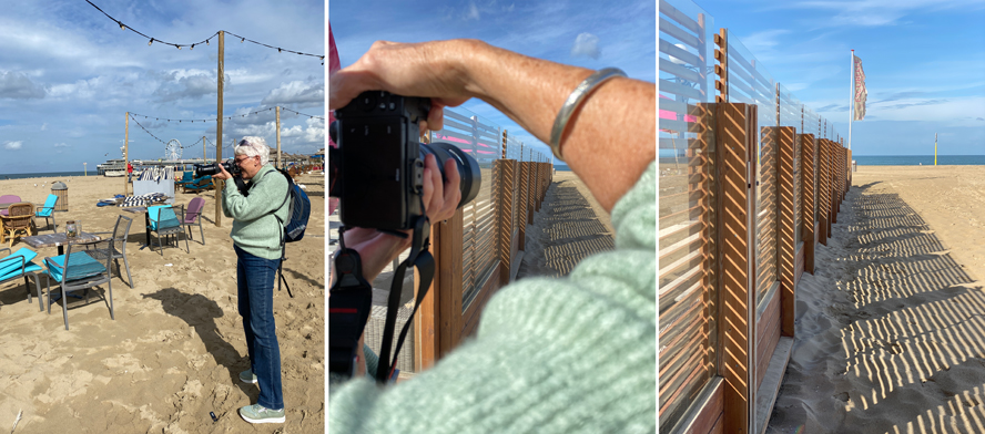 Fotografe neemt op het strand een foto van een schaduw-lijnenspel van gevlochten hekwerk te zien in het zand