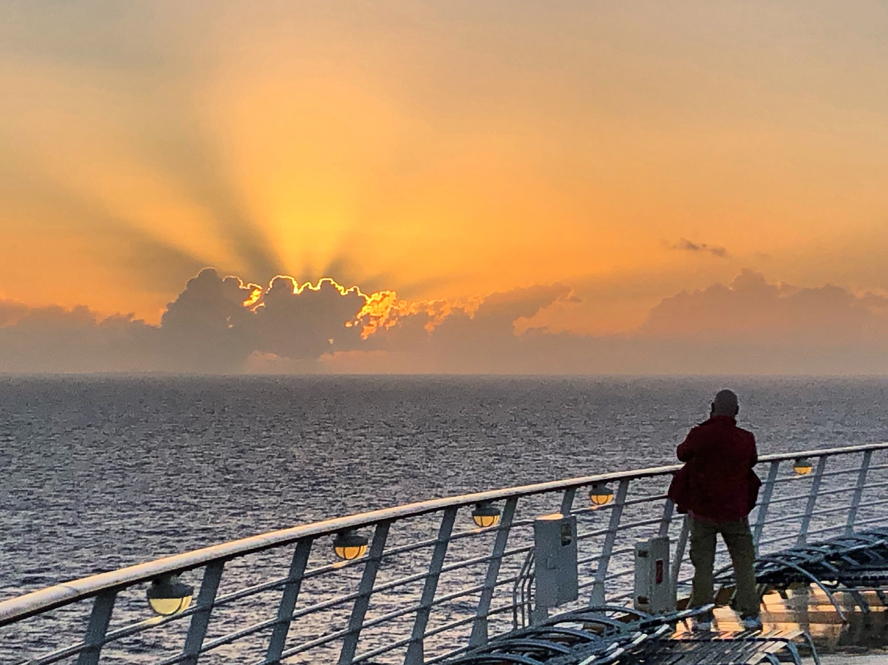 Grief cruise taking a walk on deck at sunrise